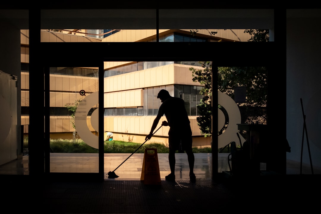services-img Man cleans floor at an entrance door.