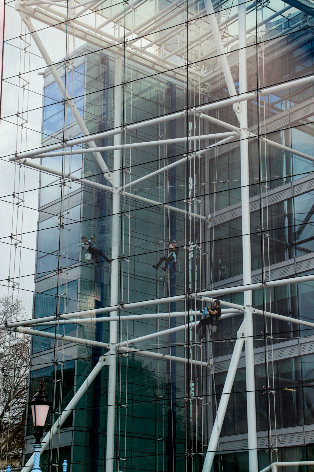 services-03 Window cleaners working from ropes on the inside of a Tower Bridge House London